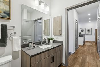 A bathroom with a white sink and a mirror above it. at The Junction at Rockledge Apartments, Rockledge 32955